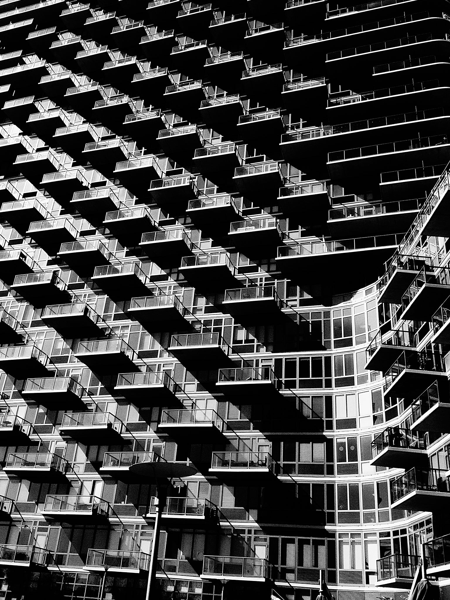 Black and white architectural photo of a modern building with balconies