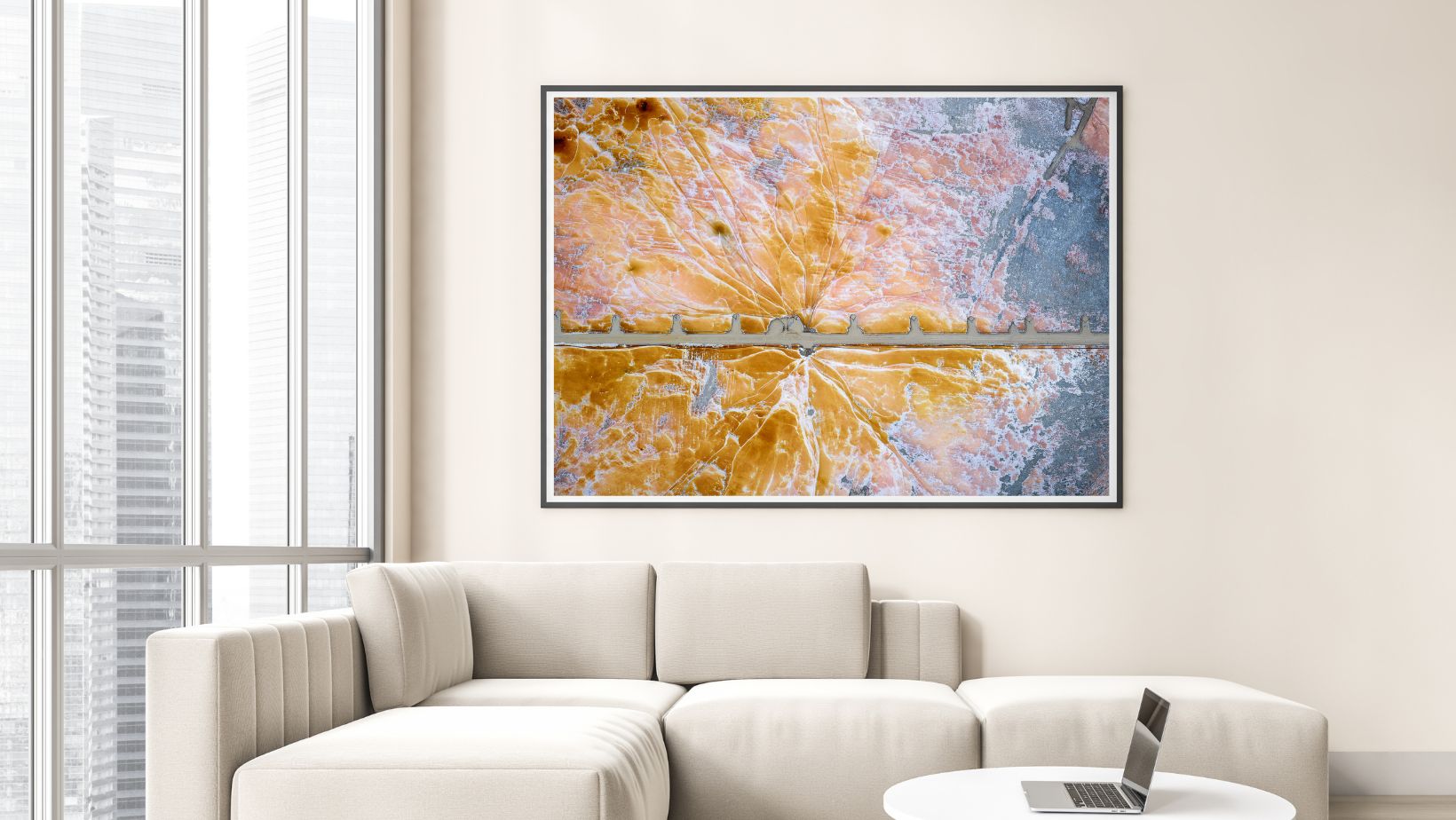 Abstract aerial photography print on a wall above a sofa in a modern living room