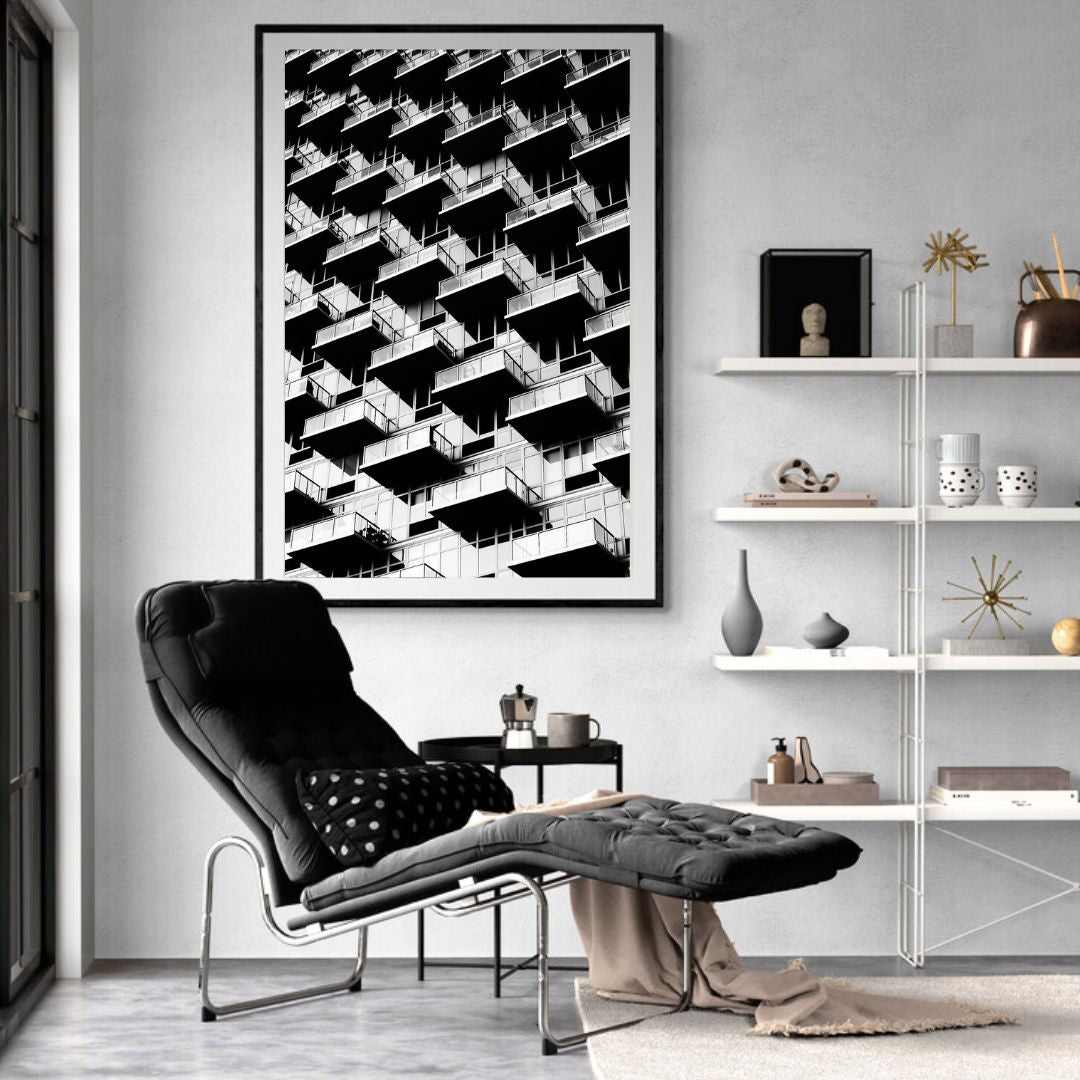 Modern living room with a black and white geometric abstract art piece on the wall.
