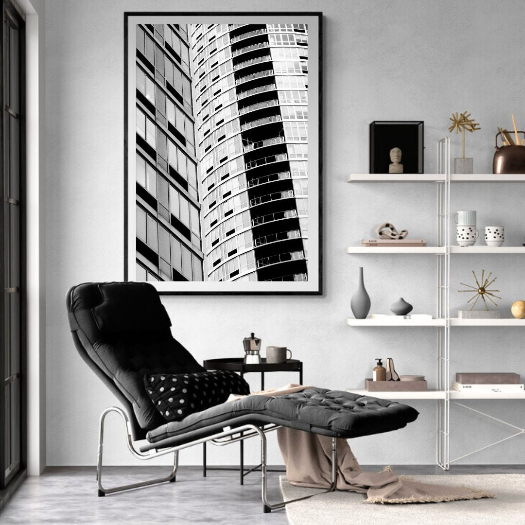 Modern living room with a black and white abstract art piece on the wall.