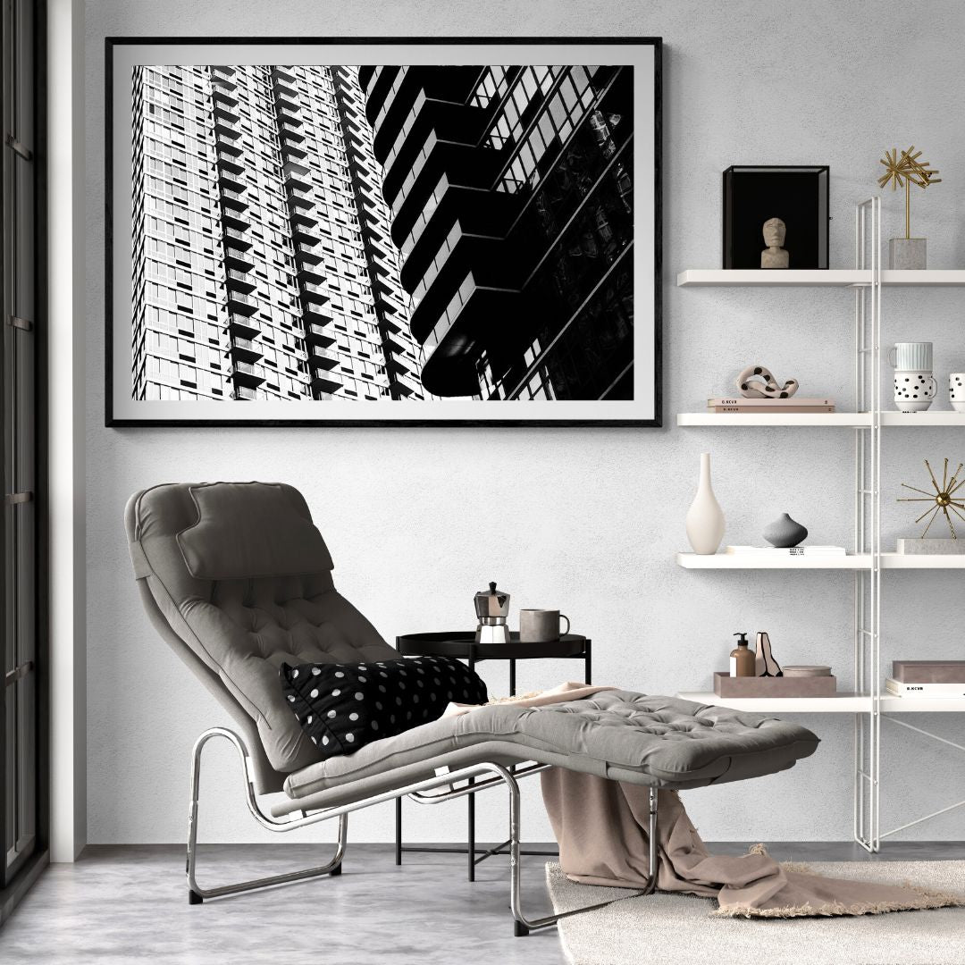Modern living room with a gray armchair, coffee table, and abstract art on the wall.