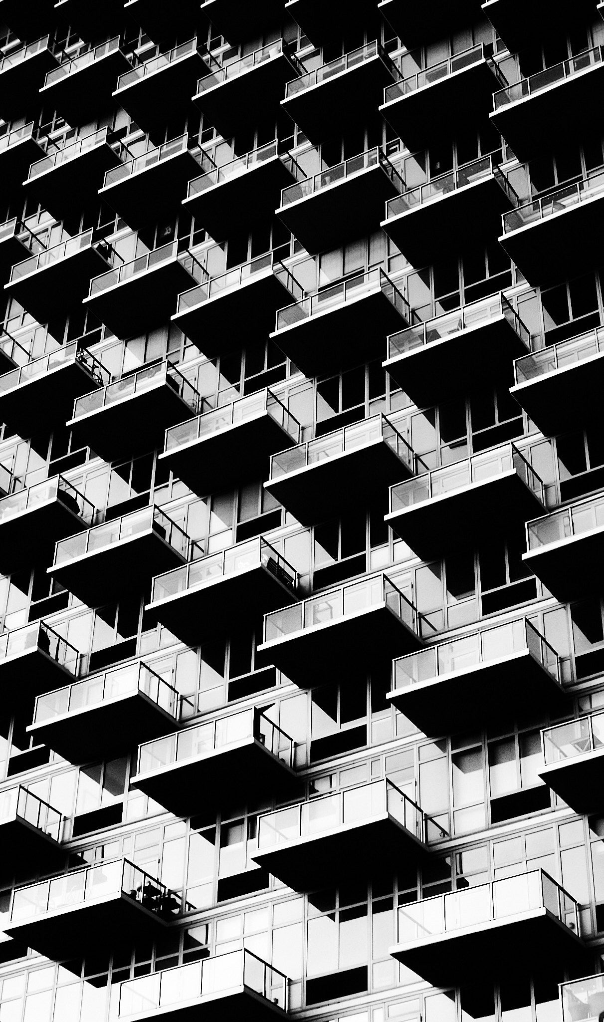 Black and white pattern of balconies on a building facade