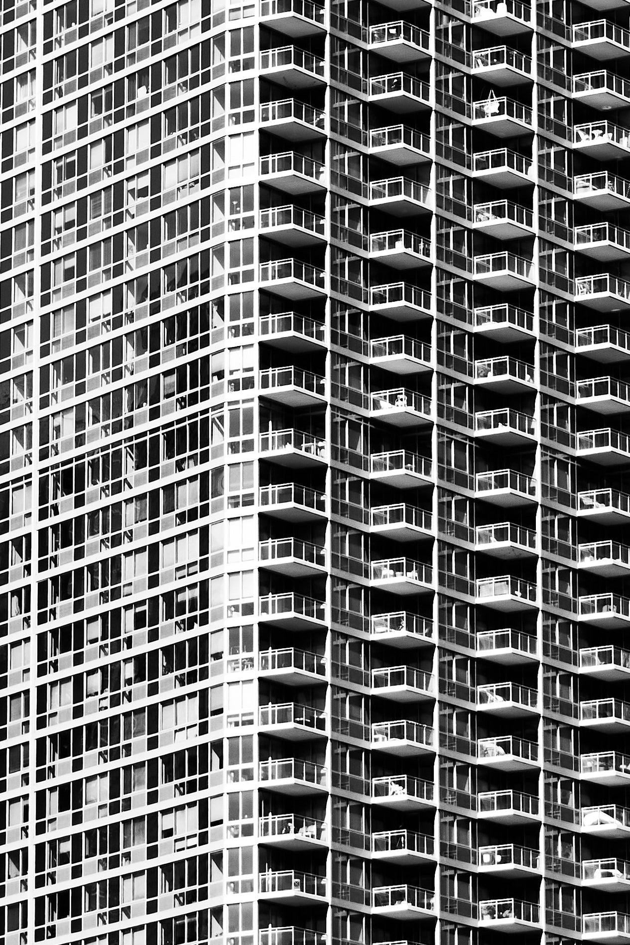Black and white image of a high-rise building with balconies