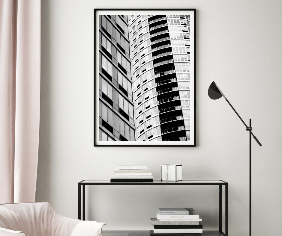 Framed black and white architectural print on a wall above a console table.