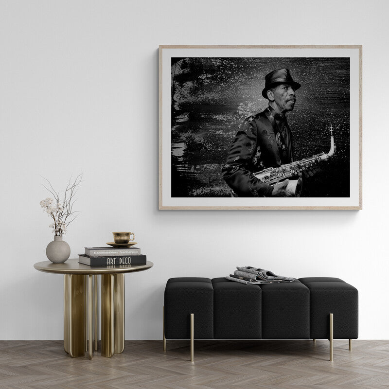 Framed black and white portrait of a musician playing saxophone in a modern living room.