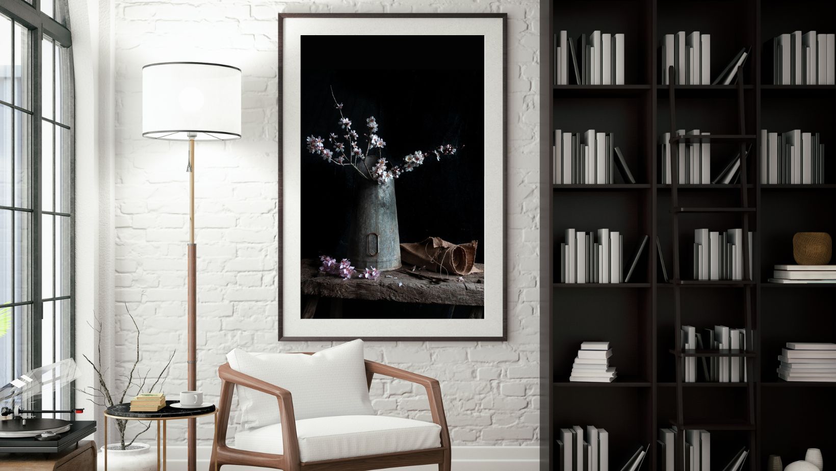 Framed artwork on a wall in a room with a bookshelf and chair.