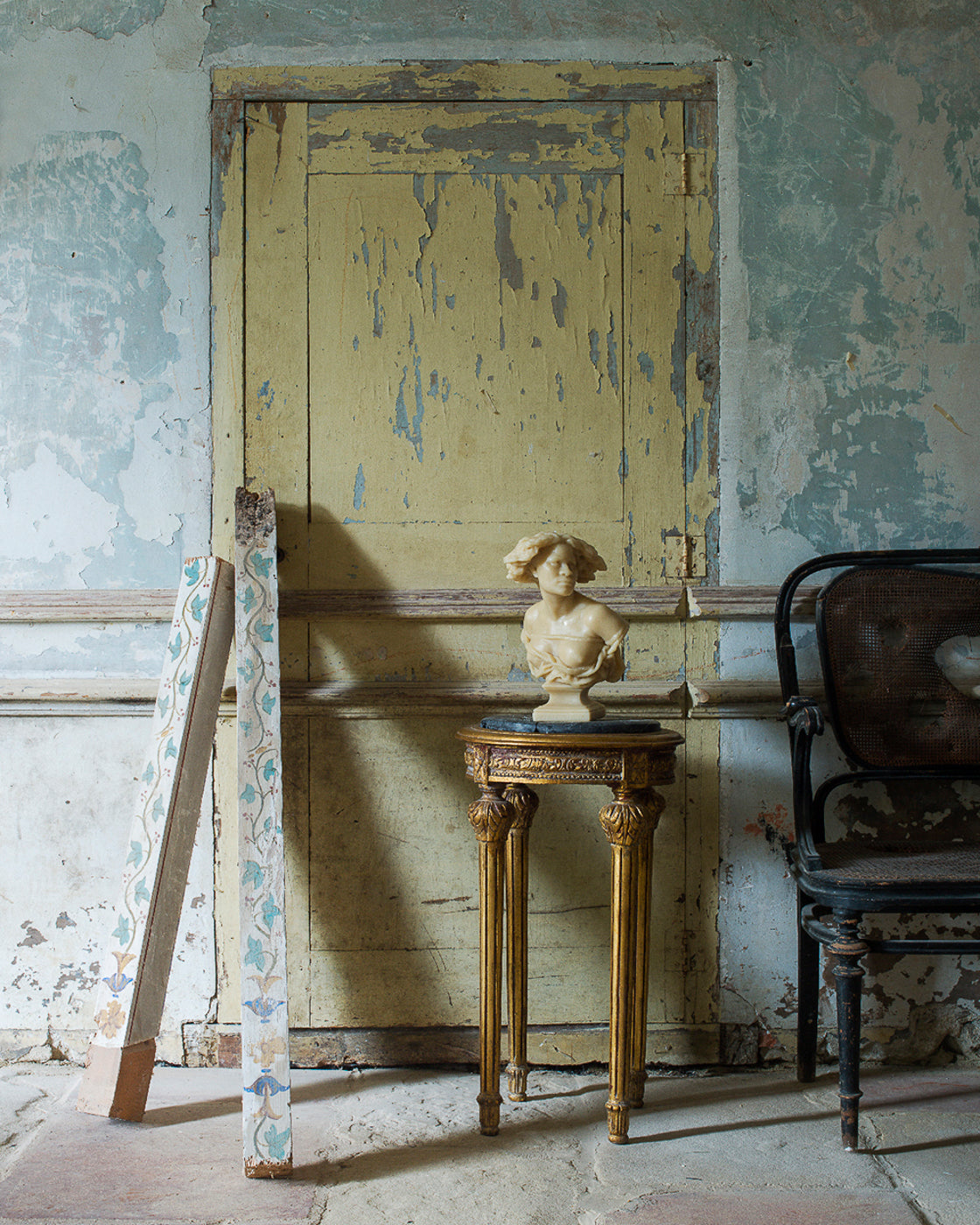Vintage interior with a yellow door, small table, and decorative elements.