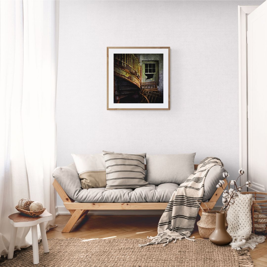 Living room with a sofa, decorative pillows, and a framed picture on the wall.