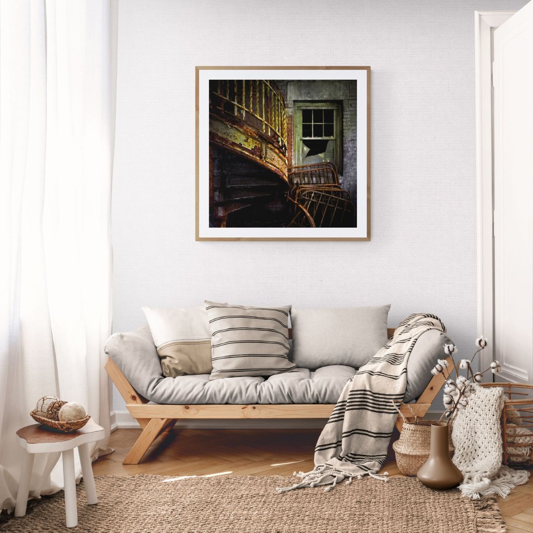 Living room with a couch, pillows, and a framed picture on the wall.