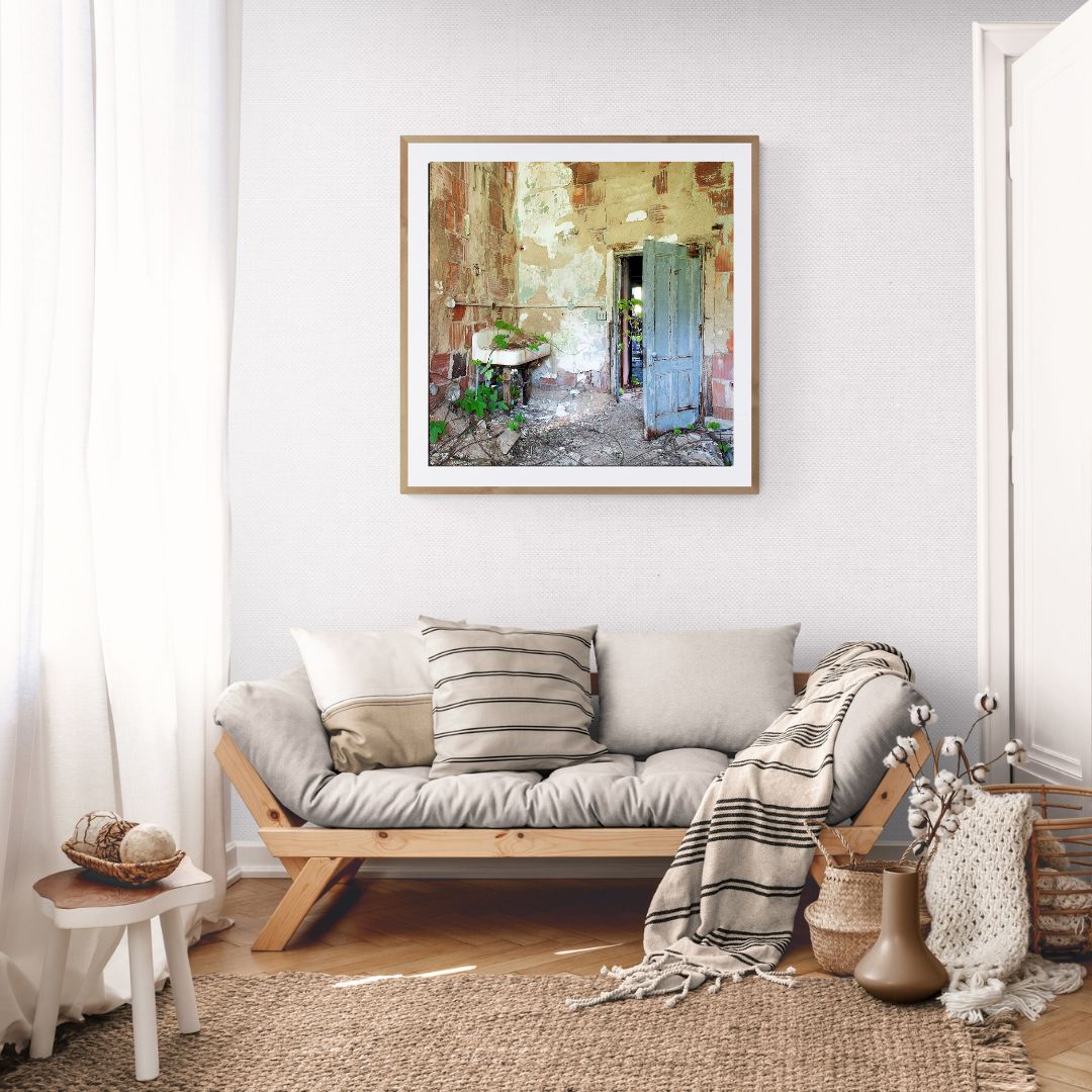 Living room with a couch, decorative pillows, and a framed picture on the wall.