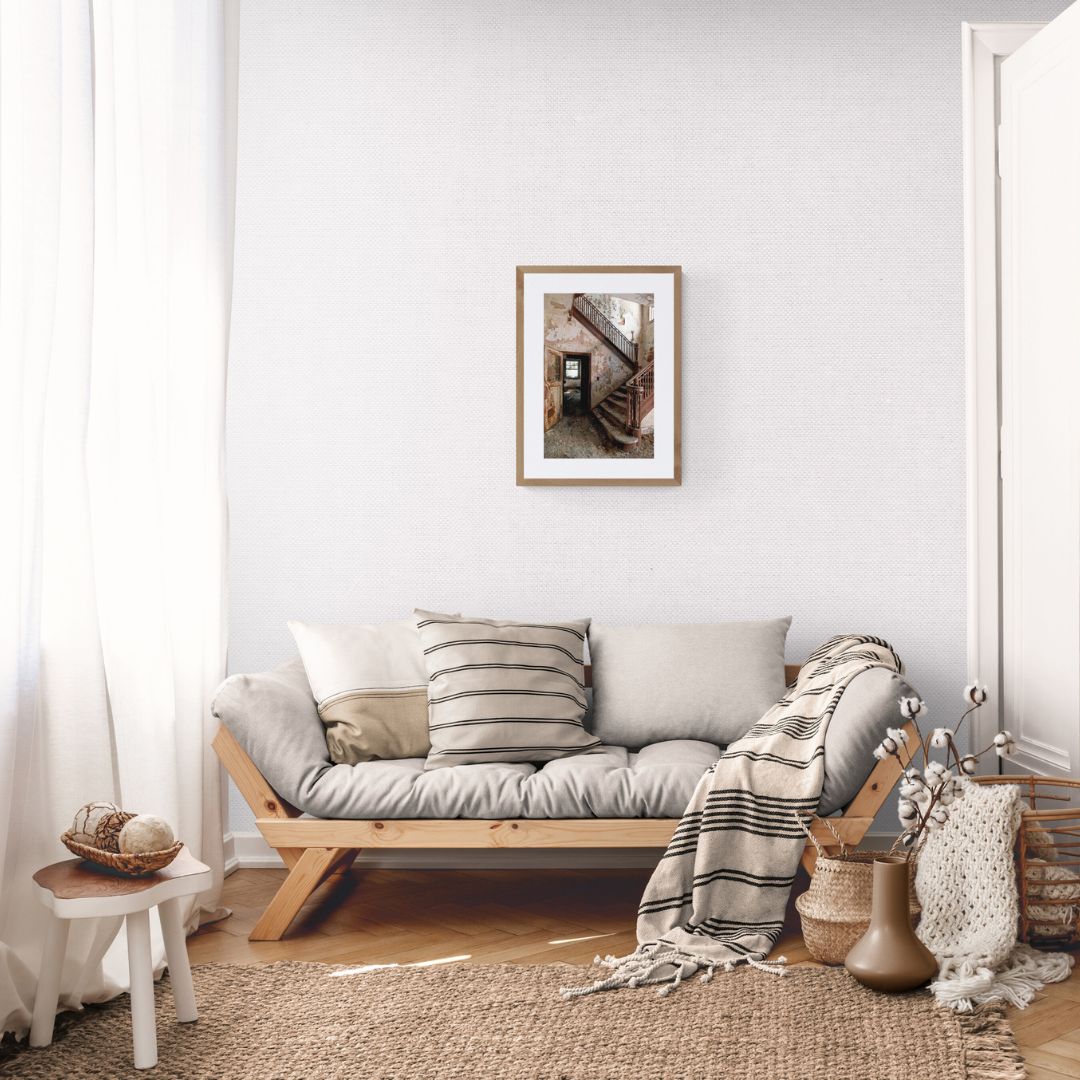 Cozy living room with a wooden sofa, cushions, and decorative items.