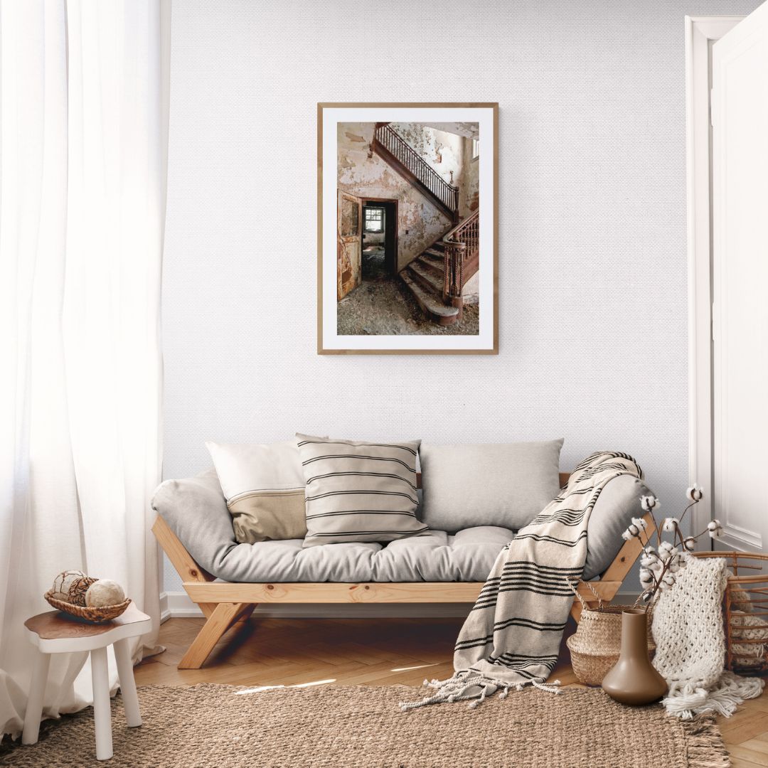 Living room with a sofa, cushions, and a framed picture on the wall.