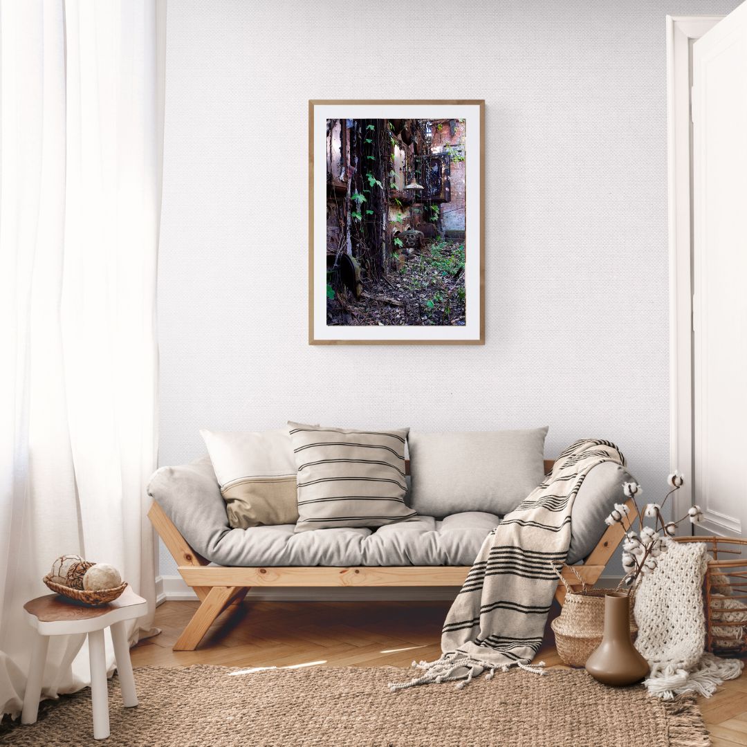Living room with a sofa, cushions, and a framed picture on the wall.