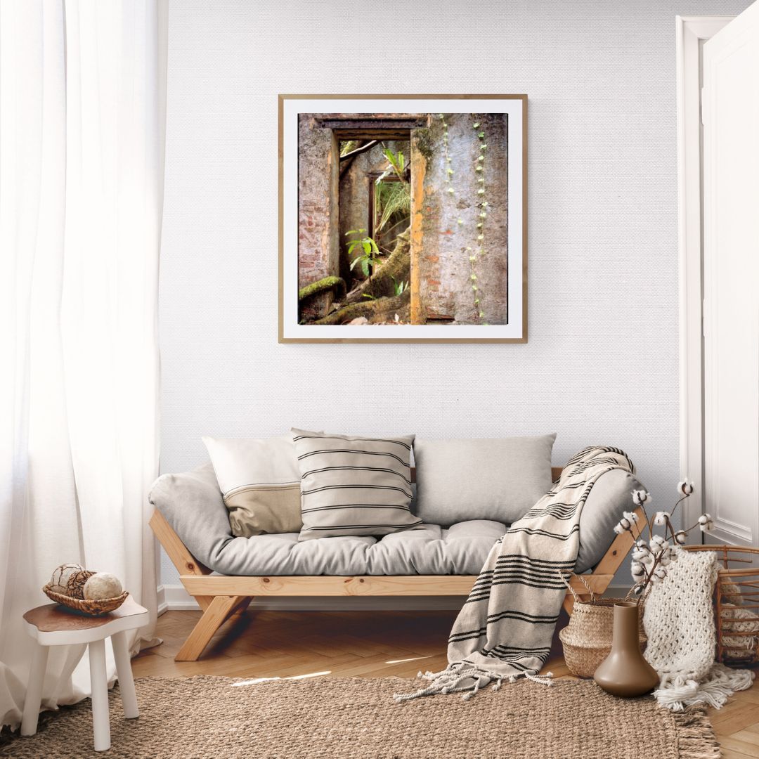 Living room with a sofa, decorative pillows, and a framed picture on the wall.