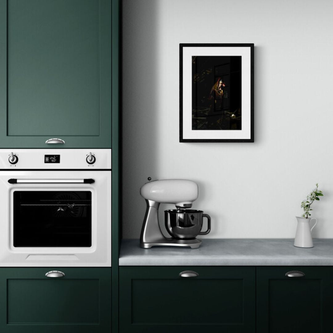 Kitchen interior with green cabinets, white appliances, and a framed picture on the wall.