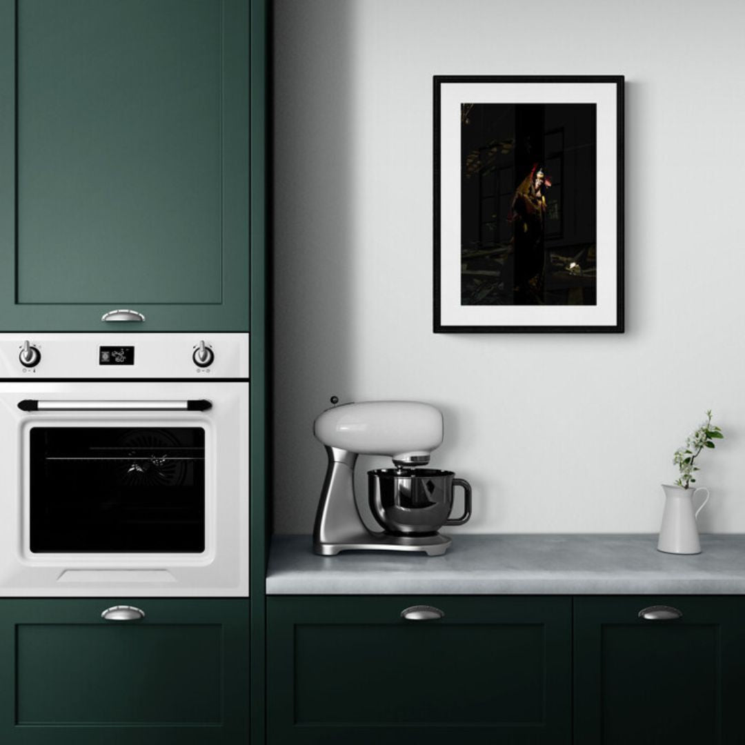 Modern kitchen with green cabinets, white appliances, and a framed picture on the wall.