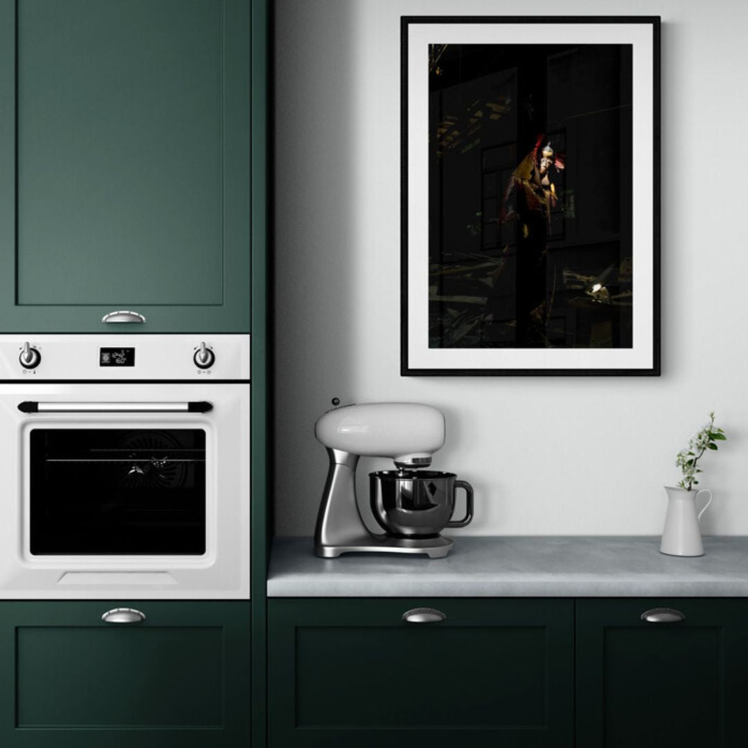 Modern kitchen with green cabinets, white appliances, and a framed picture on the wall.