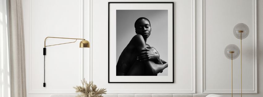 Framed black and white portrait of a person on a wall with decorative elements.