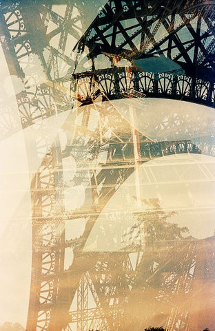 Double exposure of the Eiffel Tower and a sunset with abstract colors