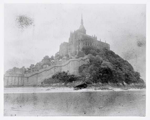 Black and white photograph of Mont Saint-Michel, a large island and Benedictine abbey in Normandy, France.