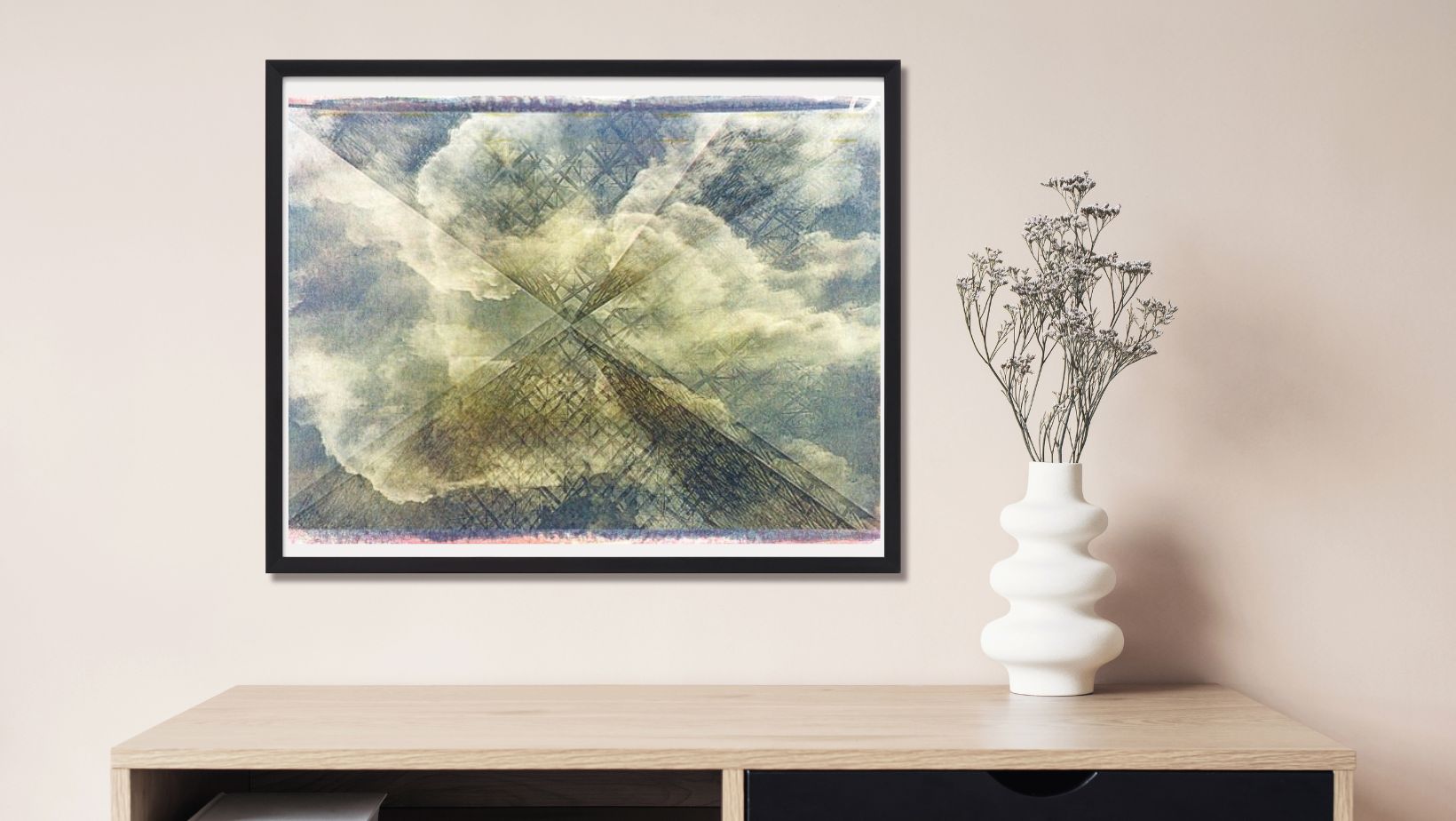 Framed abstract art piece on a wall above a wooden shelf with a vase.