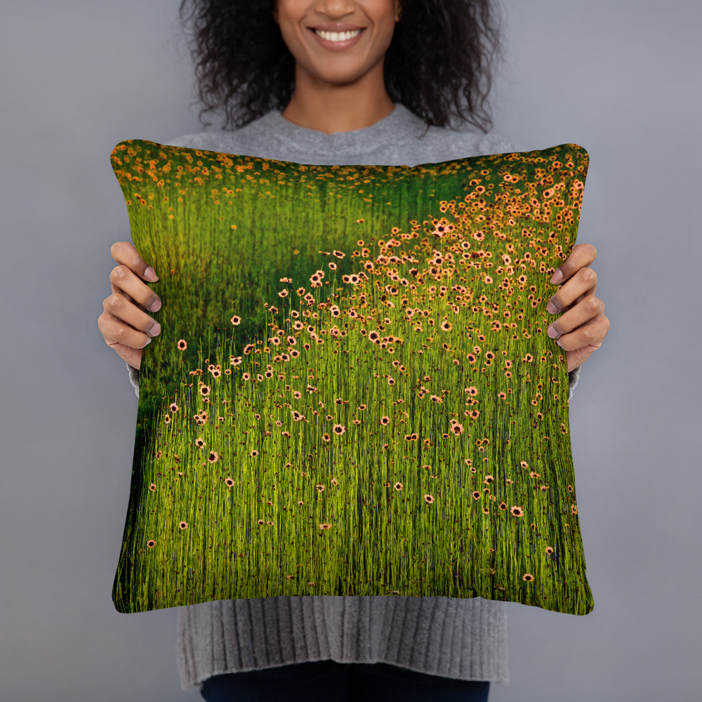 Woman holding a Square pillow with a photograph of a field of orange flowers
