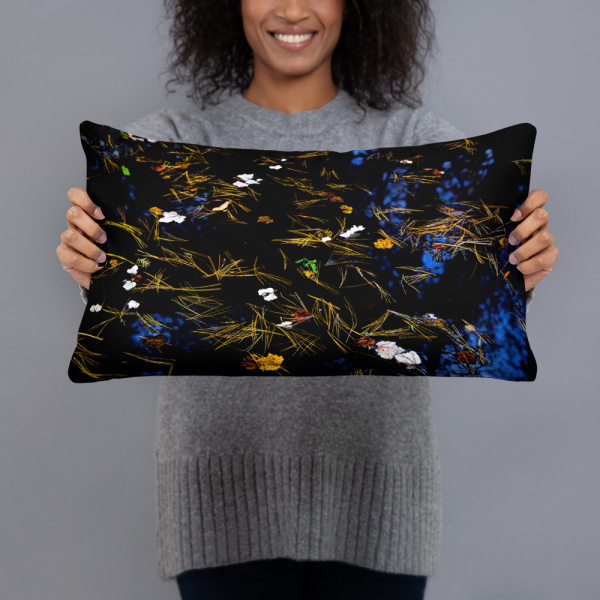 Woman holding a Rectangular pillow with the photograph of a pond with petals and leaves floating on it