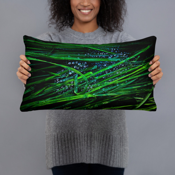 Rectangular pillow with a photograph of blades of grass with droplets on them