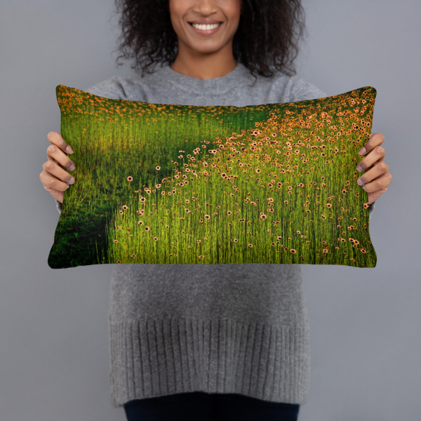 Woman holding a Rectangular pillow with a photograph of a field of orange flowers