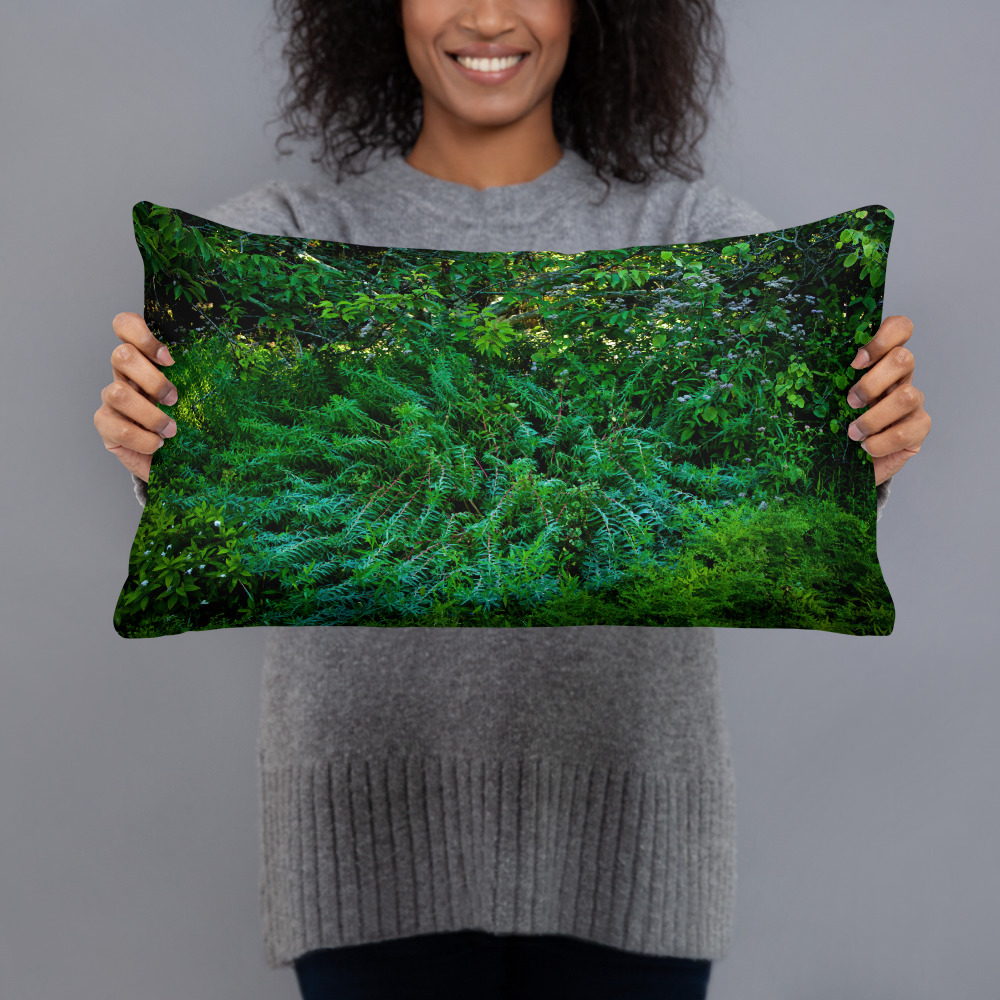 Woman holding a Rectangular pillow with a photograph of lush greenery