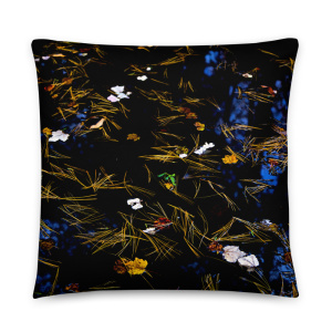 Square pillow with the photograph of a pond with petals and leaves floating on it