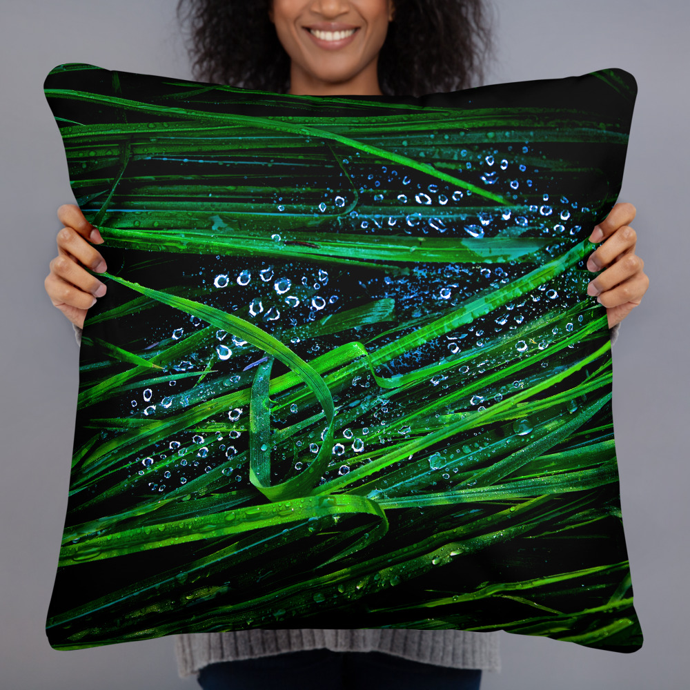Square pillow with a photograph of blades of grass with droplets on them