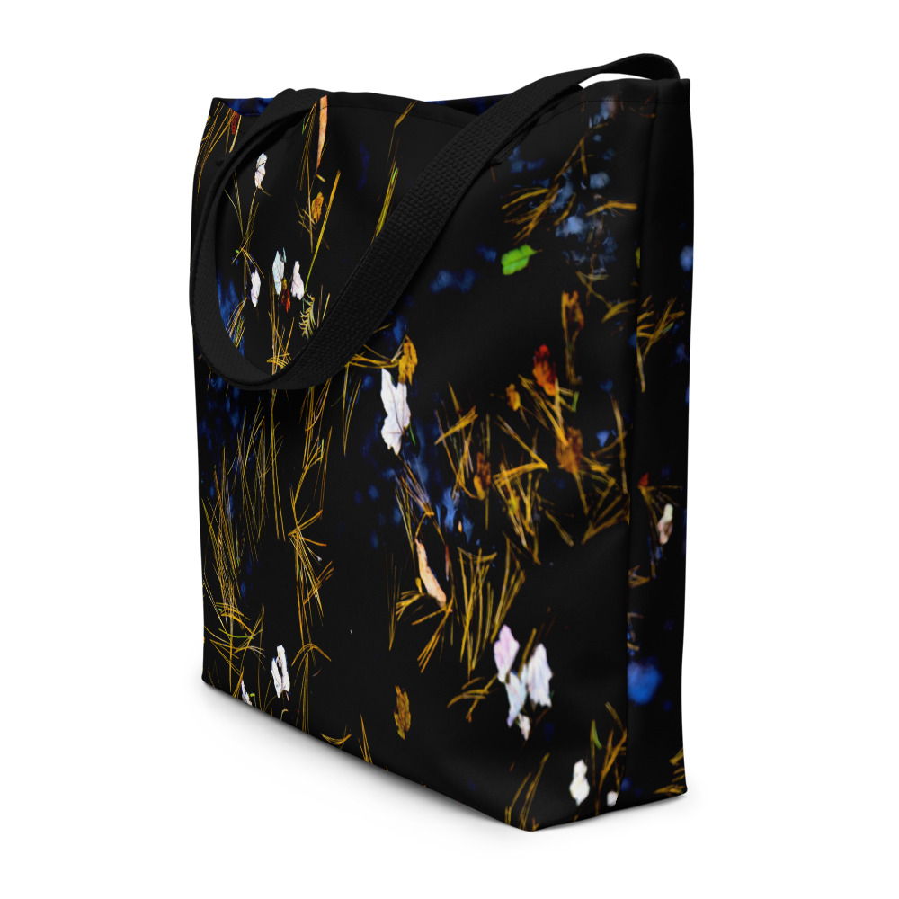 Sideview of a all-over-print large tote bag with the image of a Pond covered with fallen flower petals (black tones)