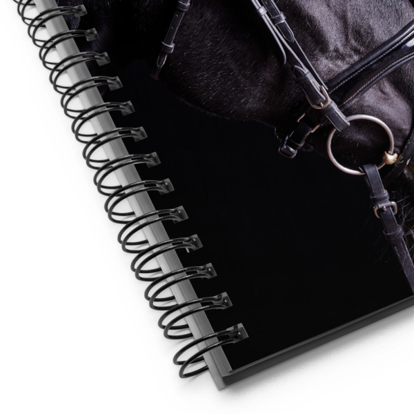 Close up of a spiral notebook with a profile of a black horse