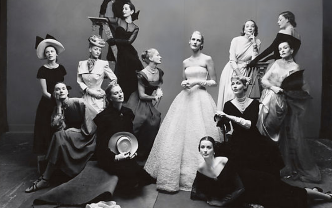 Group of models in a studio, all dressed in 1950s high fashion
