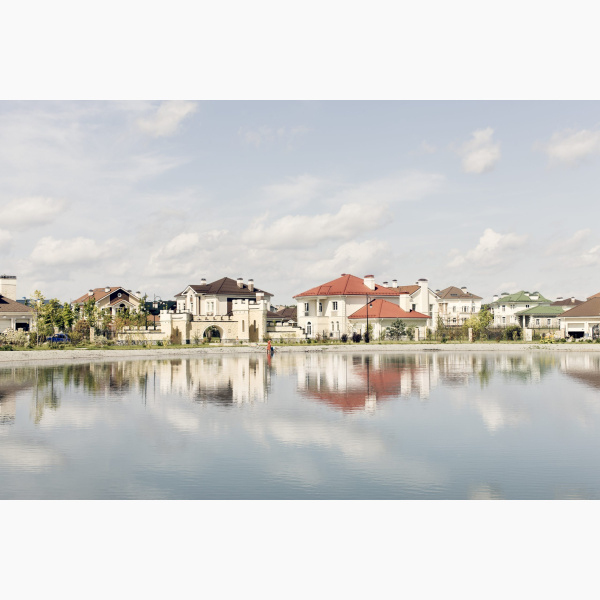 Cityscape of a suburb reflected on a lake