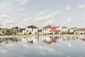 Cityscape of a suburb reflected on a lake