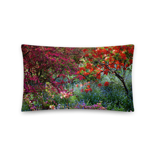 Rectangular throw pillow with a colorful photo of a shaded and flowery spot in a park
