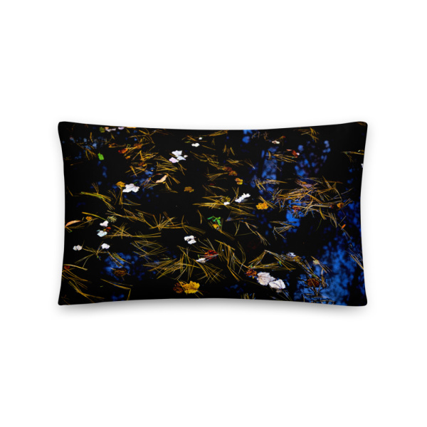 Rectangular throw pillow with the photograph of a pond with petals and leaves floating on it