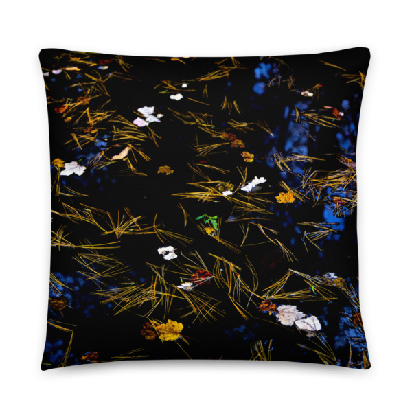 Square throw pillow with the photograph of a pond with petals and leaves floating on it