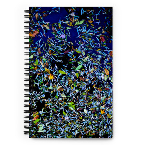 Spiral notebook with a photo of a pond covered with flower petals on its cover