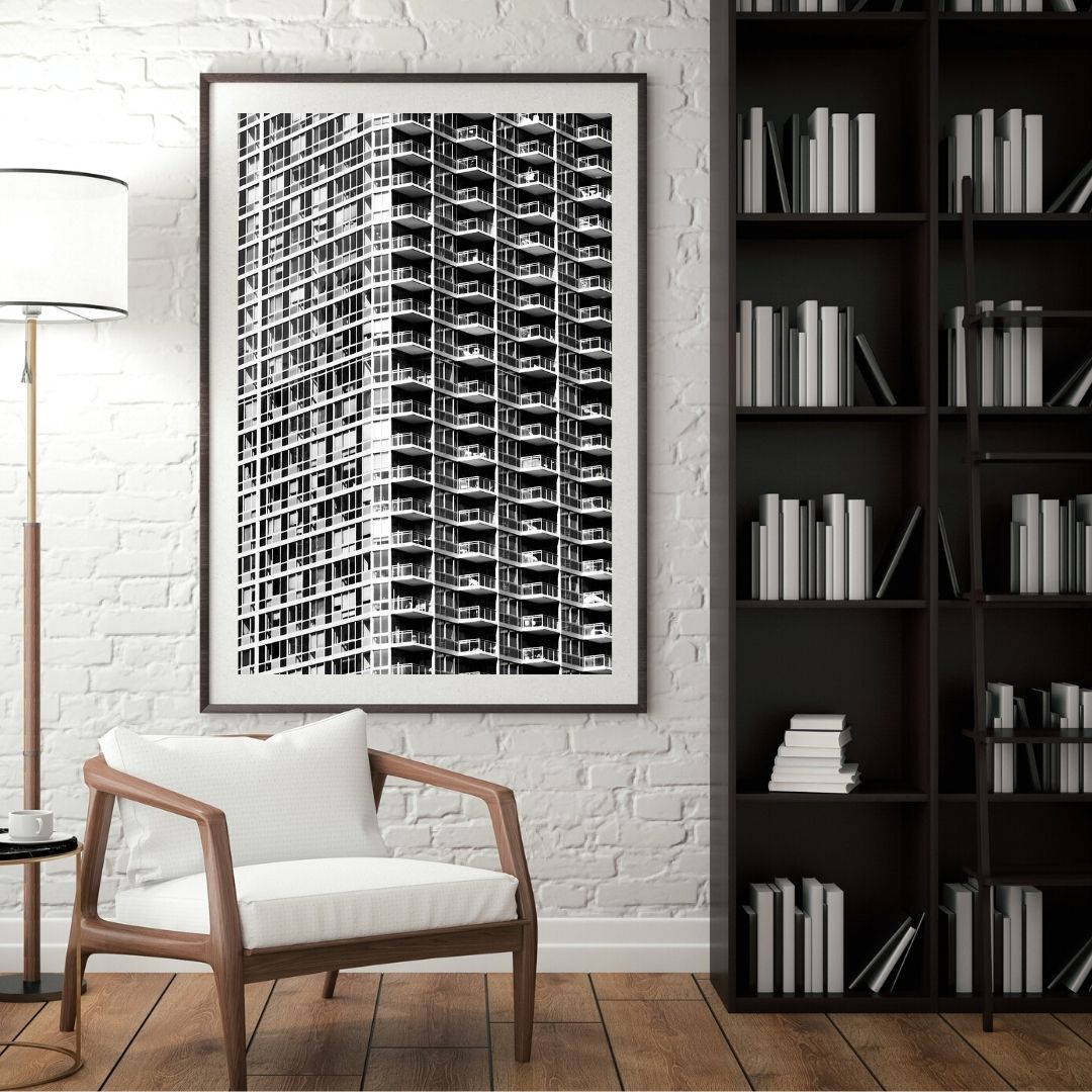 Chair near a library with a large print of New York architecture on the wall