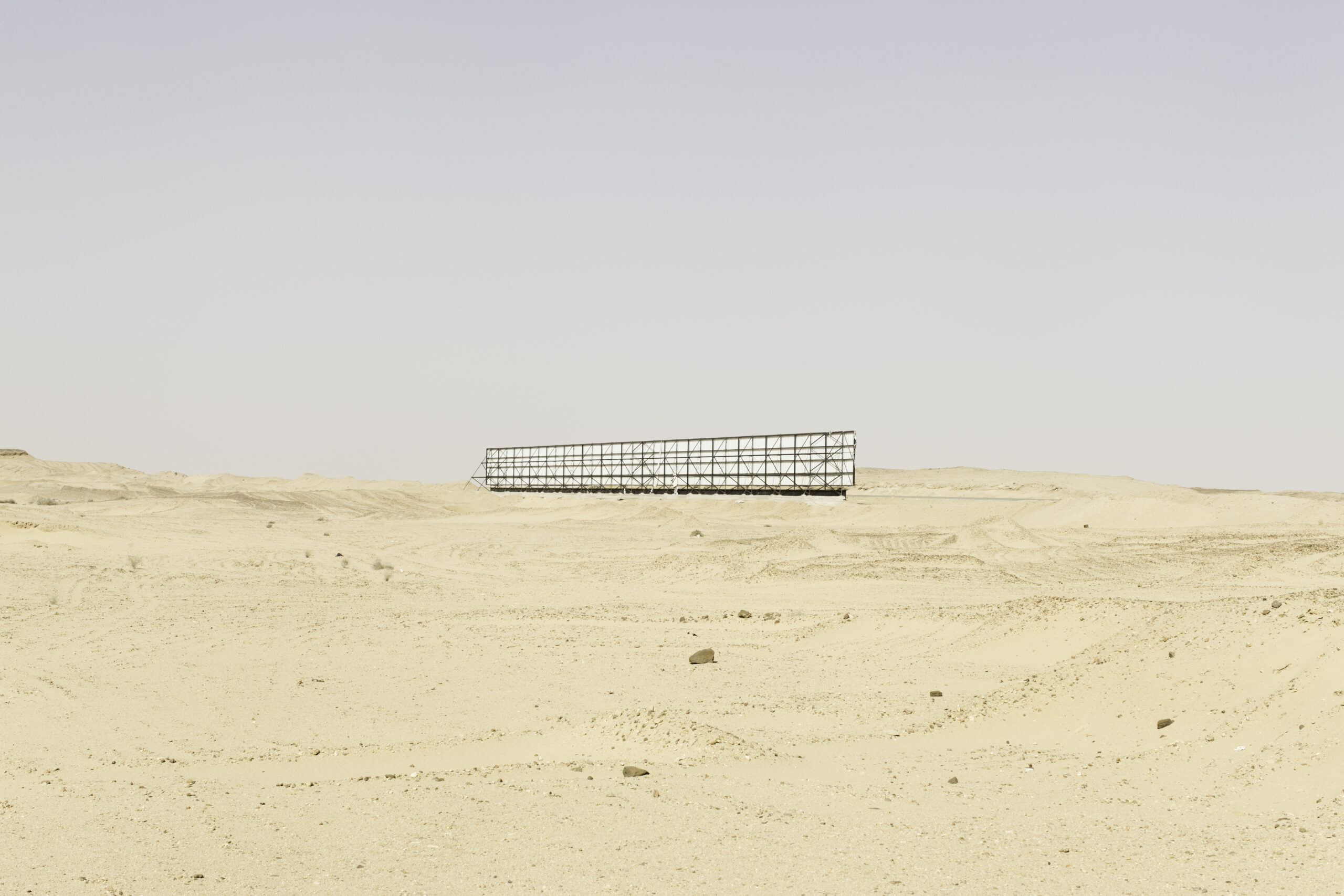 Lone billboard in the middle of a desert landscape