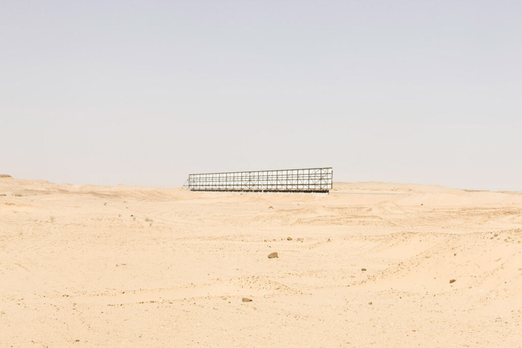 Lone billboard in the middle of a desert landscape