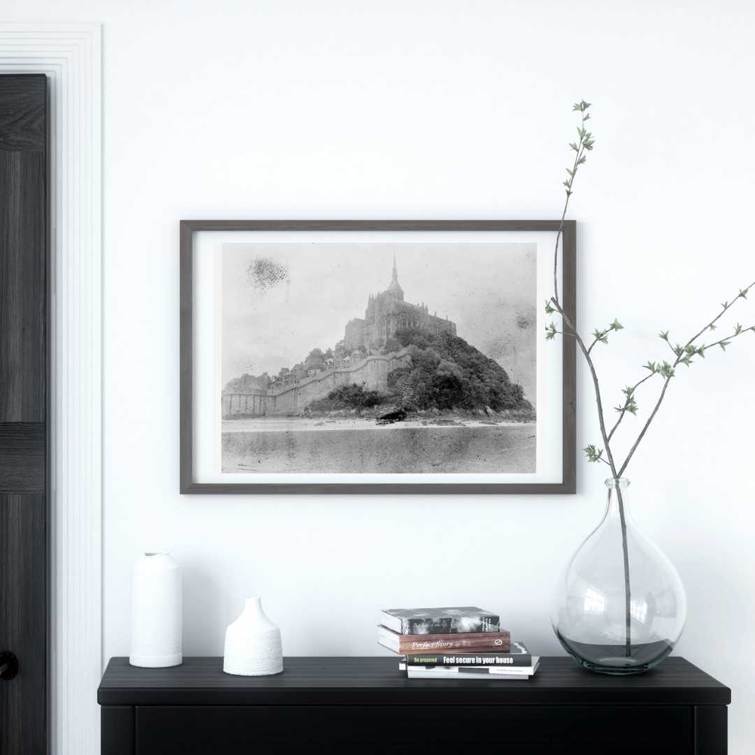 Print of a photo of Mont Saint michel above a small table in an entryway