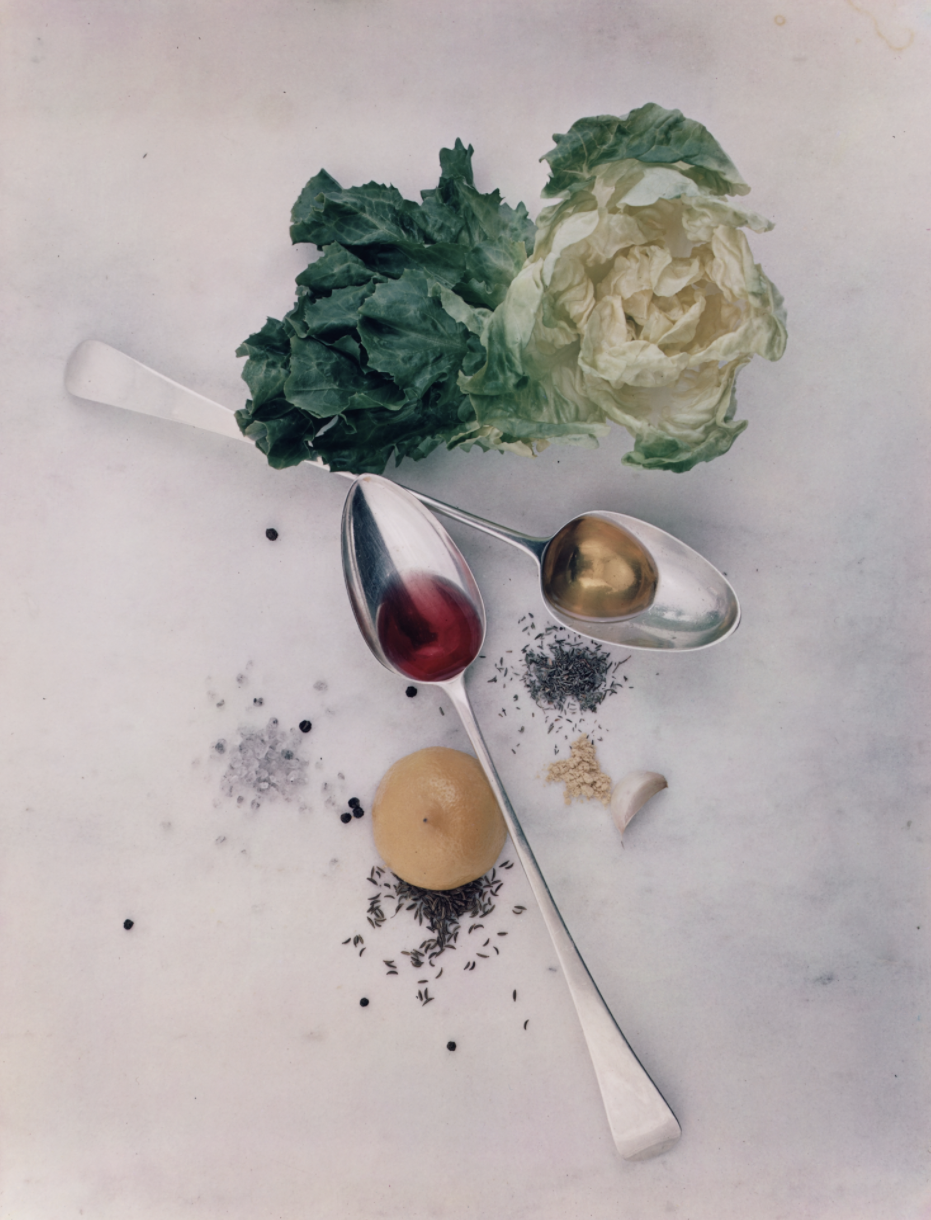 Ingredients to make a salad posed on a marble tabletop, seen from above