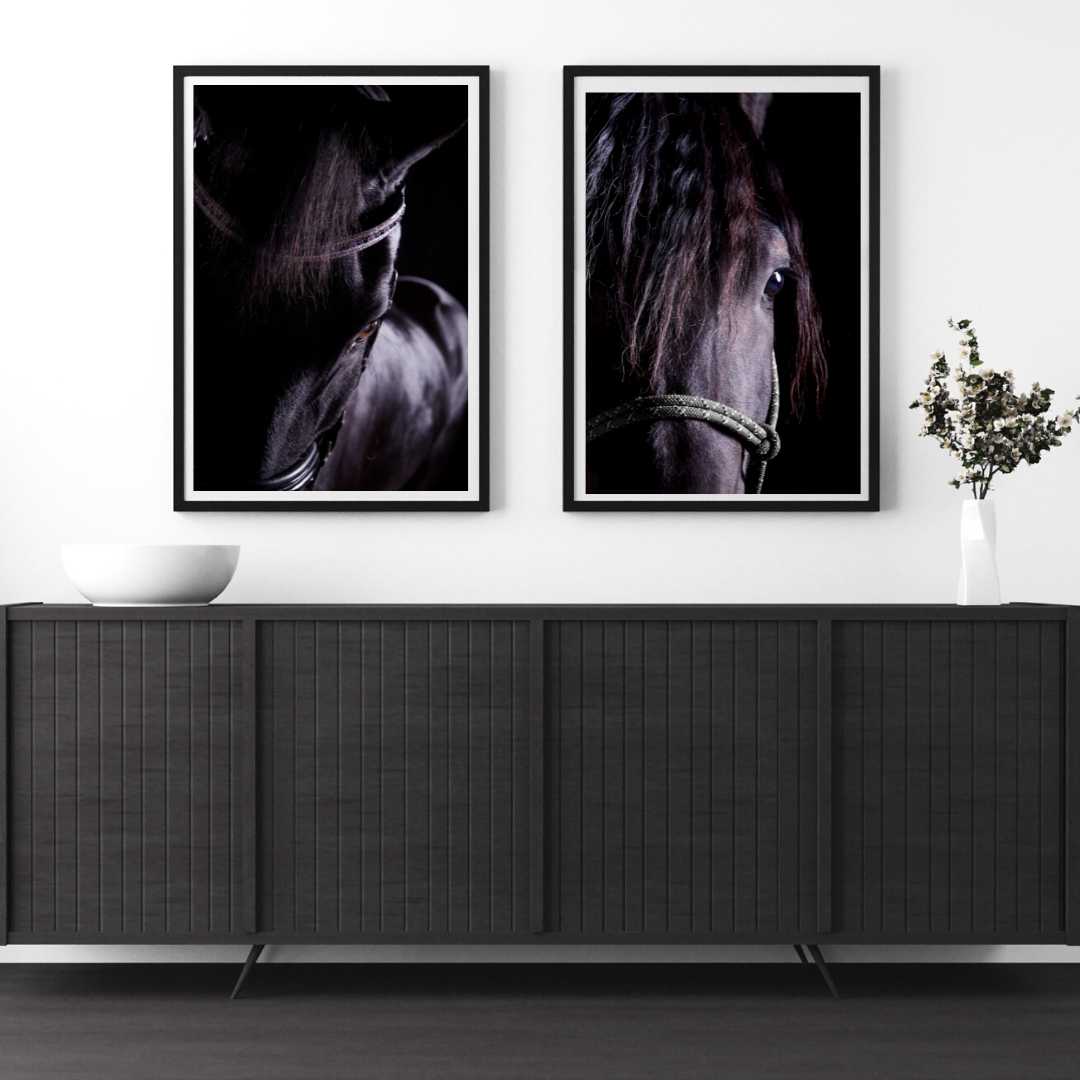 Two photo of a black horse hang above a black buffet