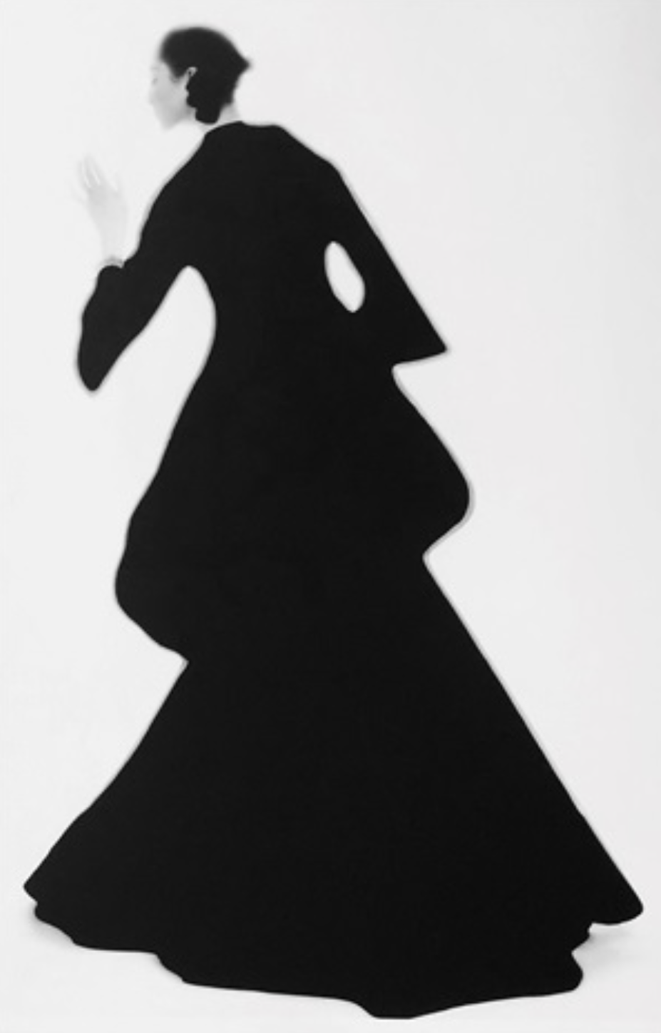 Silhouette of a woman in a long black evening gown