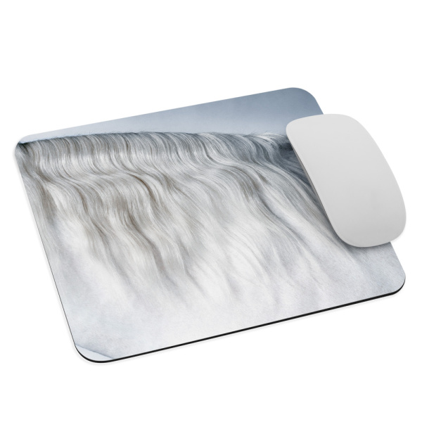 Mouse pad with a photograph of a white horse standing against a white backdrop