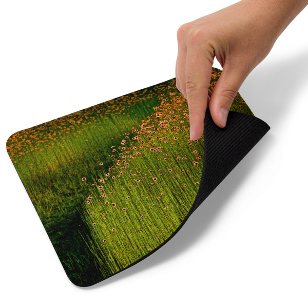 Mouse pad with a photograph of a field of tall flowers